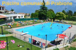 a large swimming pool with many people in it at Casa Mary apartments in Tignale