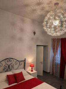 a bedroom with a bed with a large chandelier at La Casetta Noble House in Casoli
