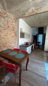 a living room with a wooden table and a kitchen at Residenza SOGNO in Biella +4 photos