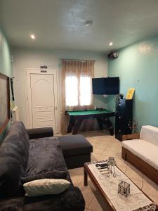a living room with a couch and a piano at Chéz Vasŏ ** leisure maisonette** in Kassandra