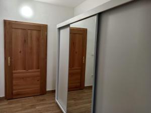 a mirror in a room with two doors at Apartmán Netolice in Netolice