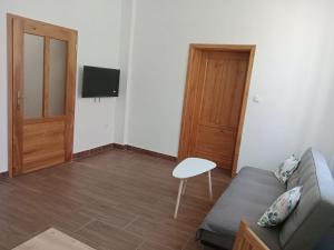 a living room with a couch and a table and a television at Apartmán Netolice in Netolice