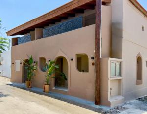 a house in the middle of a street at EROS & PATHOS Suites in Kremasti
