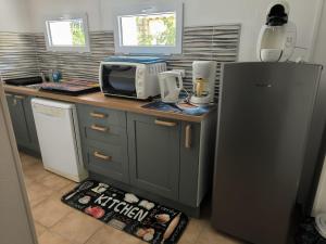 a kitchen with a refrigerator and a microwave at Sweet villa view 26 in Nyons
