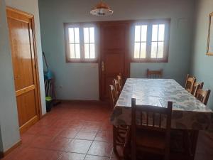a dining room with a long table and chairs at Casa rural Casa Camilo in Agüero +15 photos
