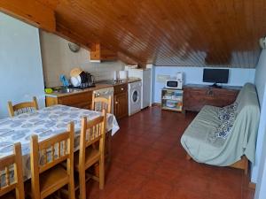 a kitchen with a dining room table and a kitchen with a tableablish at Casa rural Casa Camilo in Agüero