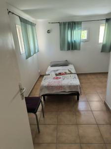 a bedroom with a bed and a chair in it at Sweet villa view 26 in Nyons