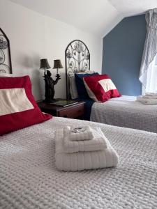 a bedroom with two beds with a towel on the bed at Cannon House Retreat in Fayetteville