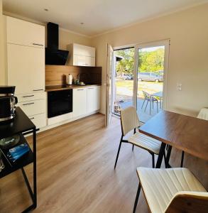 a kitchen and dining room with a table and chairs at Ferienwohnungen Soldanski in Loddin
