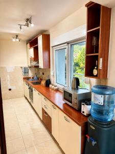 a kitchen with a counter and a window in it at Penthouse Bečići Apartament in Bečići