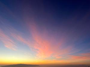 a sunset with a blue and orange sky at Nido del Sol in Guía de Isora +1 photo