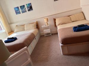 a room with two beds in a room at Mirage Hotel in Blackpool