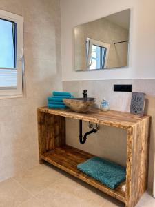 a bathroom with a sink and a mirror at Ferienwohnungen Soldanski in Loddin +13 photos