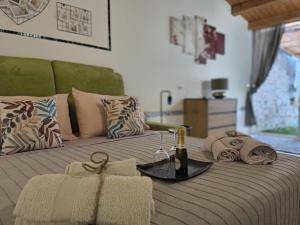 a bed with a bottle of wine and a glass at THE KING'S LOFT Loft del Rè Sebi in Villasmundo