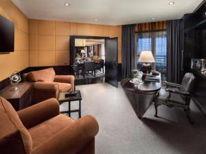 a living room with a couch and a table at Fairmont Nile City in Cairo