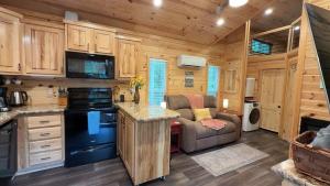 a kitchen and living room in a log cabin at Mentone Tranquility Base with Hot Tub in Mentone +24 photos