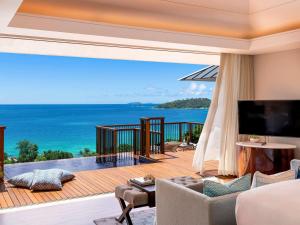 a living room with a view of the ocean at Raffles Seychelles in Baie Sainte Anne