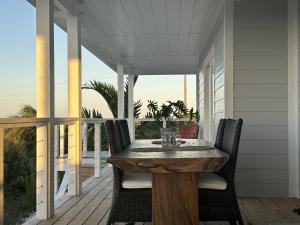 a wooden table on the porch of a house at The View Villa in Hartswell