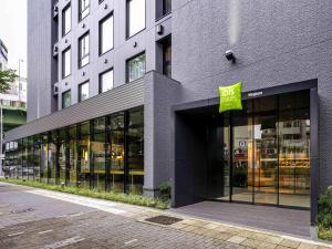 a store front of a building with a sign on it at ibis Styles Nagoya in Nagoya