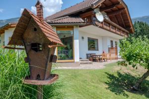 a house with a bird house in front of it at Haus Fine in Millstatt