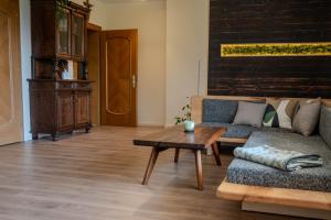 a living room with a couch and a coffee table at Haus Fine in Millstatt +24 photos