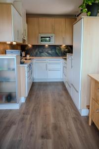 a kitchen with white appliances and wooden cabinets at Haus Fine in Millstatt
