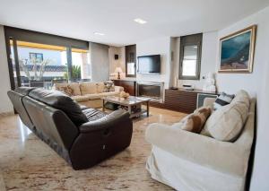 a living room with two couches and a tv at Casa La Vinya "Alto Standing" in Palamós +38 photos
