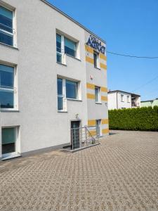 a white building with a sign on the side of it at Villa AGNAT in Gdańsk