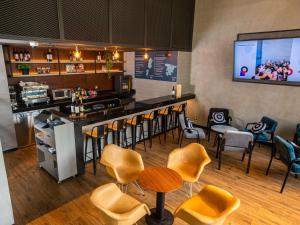 a bar with chairs and a counter in a restaurant at ibis styles Lima San Isidro in Lima