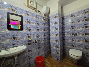 a bathroom with a toilet and a sink at Hotel JBL in kolkata