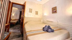 a bedroom with two beds and a mirror at Michele Marie apts in Agia Pelagia