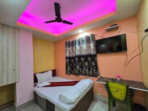 a room with a purple light on the ceiling at Hotel JBL in kolkata