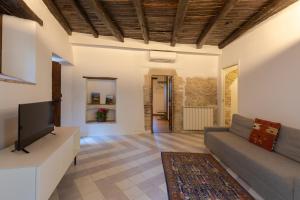 a living room with a couch and a tv at Borgo San Valentino in Arrone