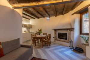 a living room with a table and a fireplace at Borgo San Valentino in Arrone