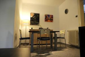 a dining room with a table and four chairs at Q-Art Hidden Garden City Centre in Novi Sad +14 photos