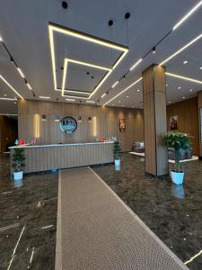a lobby of a hotel with potted plants in it at Polaris resort in Almaty