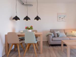 a living room with a table and a couch at Ohlerich Speicher App_ 20 in Wismar