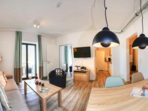 a living room with a couch and a table at Ohlerich Speicher App_ 20 in Wismar