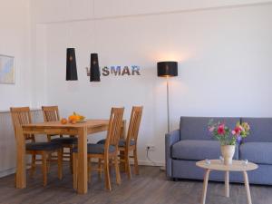 a living room with a table and a blue couch at Ohlerich Speicher App_ 10 in Wismar