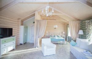 a living room with a couch and a chandelier at French Town in Berehove