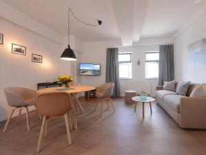 a living room with a couch and a table at Ohlerich Speicher App_ 25 in Wismar
