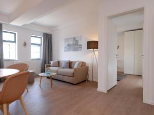 a living room with a couch and a table at Ohlerich Speicher App_ 25 in Wismar