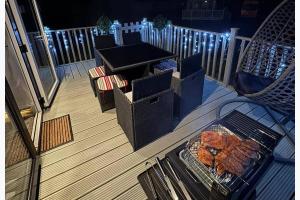 a grill on a deck with food on it at StaticCaravan-6Berth-DogFriendly in Northampton