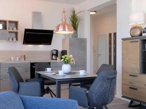 a dining room with a table and chairs at Ohlerich Speicher App_ 46 in Wismar