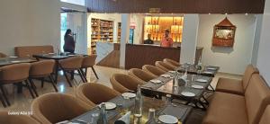 a restaurant with tables and chairs and a bar at Hotel Srirangasthalam in Chitradurga