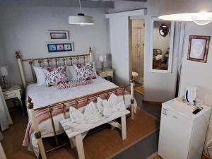 a bedroom with a bed with white shoes on it at Grace Walk Guest House in Swellendam