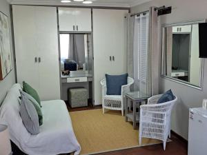 a living room with a couch and chairs and a table at Grace Walk Guest House in Swellendam