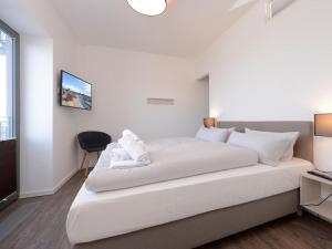 a large white bed in a room with a window at Ohlerich Speicher App_ 27 in Wismar