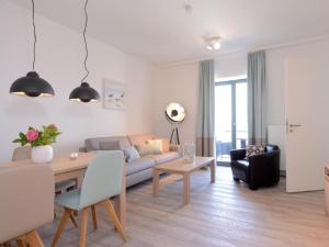 a living room with a couch and a table at Ohlerich Speicher App_ 20 in Wismar