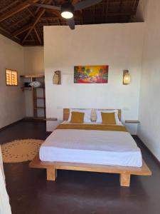 a bedroom with a large bed in a room at Mahé Lodge, Nosy Be in Nosy Be